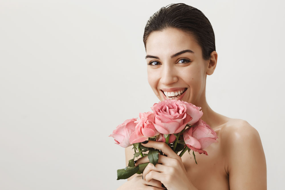 happy-beautiful-woman-standing-naked-laughing-as-receive-bouquet-roses